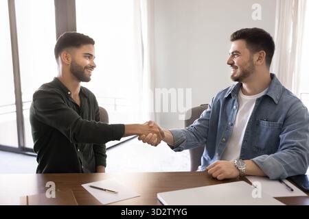 Two men shaking hands after business agreement Stock Photo