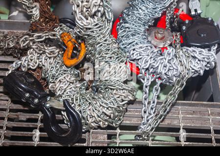 Chain hoists for lifting weights in a workshop close-up Stock Photo