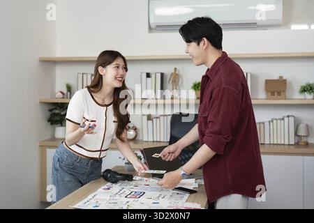 Two young professionals engage in a collaborative UX and UI design session, sharing ideas and sketches in a modern workspace Stock Photo