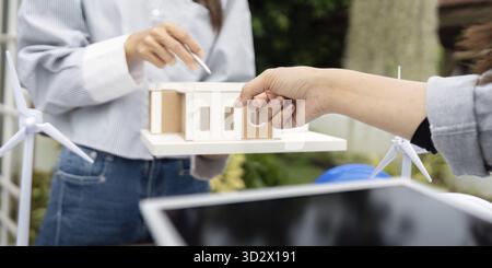 A sustainability engineer showcasing eco-friendly building concepts and renewable energy solutions in an outdoor setting, emphasizing innovation and c Stock Photo