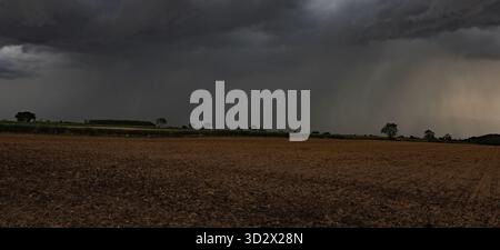 Storm clouds are gathering over the harvested corn fields of the Yorkshire Wolds near Kelk between Driffield and the east coast. Stock Photo