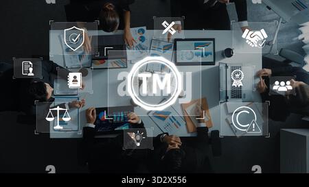 A dynamic business meeting featuring diverse professionals engaged in discussions about trademark and intellectual property strategies while analyzing Stock Photo
