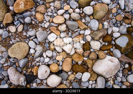 Pebbles of assorted sizes and colours, on a beach in Lancashire, UK Stock Photo