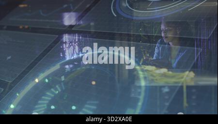 Interacting woman wearing shirt and glasses with holograms at console workstation, copy space Stock Photo