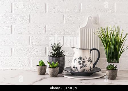 Beautiful kitchen background in gray and white tones with kitchen utensils and utensils. White brick wall in the modern interior of the kitchen Stock Photo