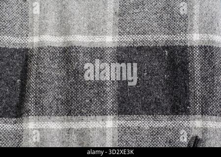 Texture of wool fabric in black and white colors. Checkered plaid, noisy structure Stock Photo