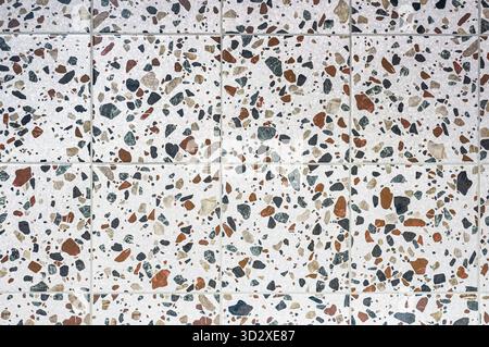 The texture of ceramic terrazzo tiles, many different granular inclusions from multi-colored pebbles Stock Photo