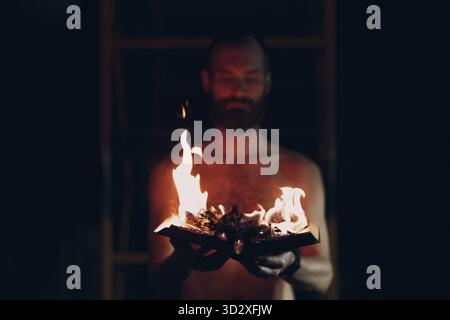 Man hold burning book in his hands Stock Photo