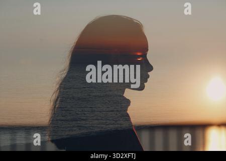 Young beautiful woman profile silhouette portrait at sunset Stock Photo
