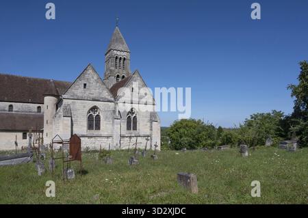 Historic facade of the Eglise Saint-Gervais in Pontpoint. The church with its Romanesque bell tower and Gothic windows (annexes) made of light stone Stock Photo