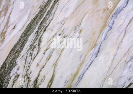 High-resolution marble texture featuring golden and gray veins on a smooth surface Stock Photo