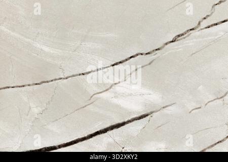 Large format texture, light cream marble with dark diagonal veins and cracks, warm color Stock Photo
