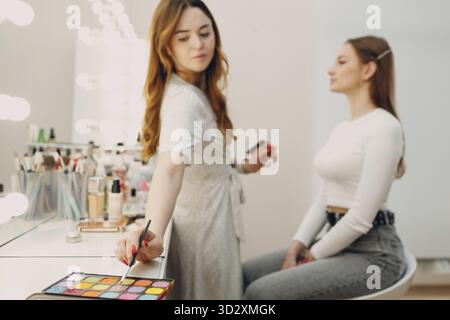 Beautiful young woman applying makeup beauty visage brush Stock Photo