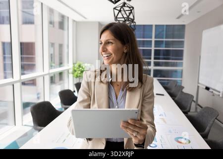 Cheerful successful company leader woman analyzing KPI Stock Photo
