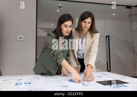 Two diverse female analysts working on project marketing strategy Stock Photo