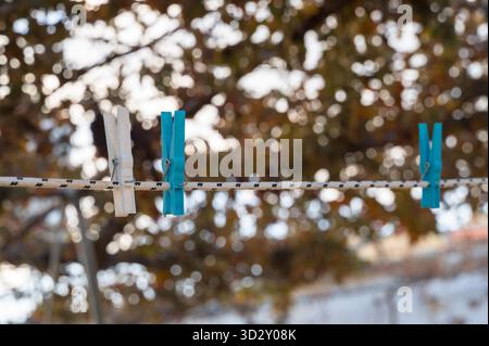 Sunlit laundry hanging on rustic fence, Peaceful outdoor scene with hanging clothes and gentle sunlight, Calm and serene summer day with clothes Stock Photo