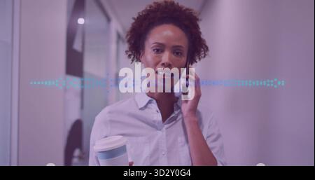 Talking woman in shirt juggling smartphone and lidded cup in office corridor, waveform overlay Stock Photo
