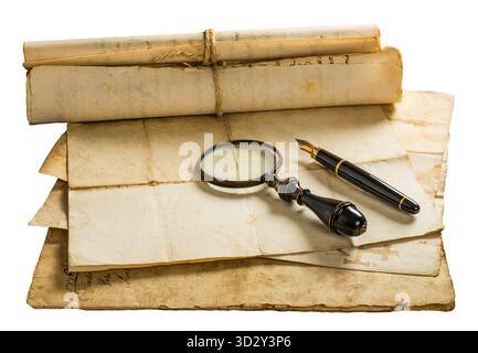 Fountain pen and magnifying glass with old sheets isolated on withe background Stock Photo