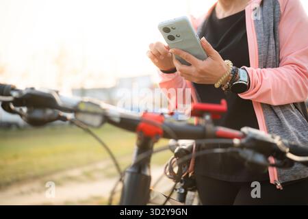 Woman Checking Bike Route On A Smartphone With Gps Map Stock Photo