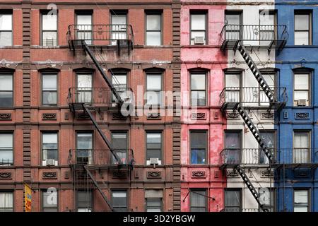 New York City, NY, United States: The architectural texture and fire escapes on a row of old brick buildings in Midtown Manhattan Stock Photo