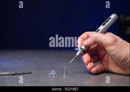 Electric mini screwdriver and several different interchangeable bits Stock Photo