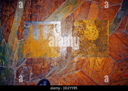 Rusty metal plate patterns and tool marks on authentic parquet, captured in analog film with flash to highlight texture and detail. Stock Photo