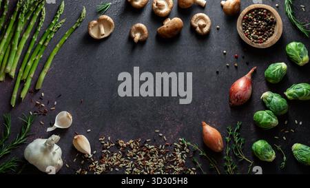 Various fresh whole raw organic ingredients arranged in a frame with copy space. Stock Photo
