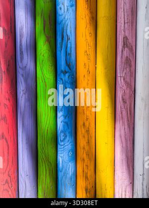 Brightness background of multicolored aged timber posts, with knots and cracks. Stock Photo