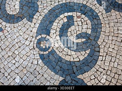 Avenida da Liberdade. Blue and white Portuguese pavement mosaic made of small limestone and basalt stones forming a decorative pattern Stock Photo