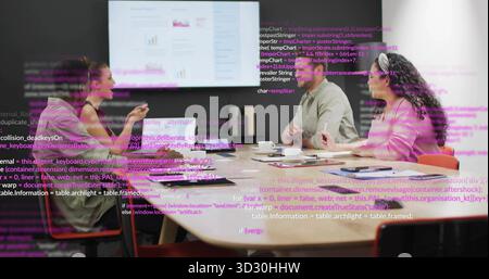 Collaborating software team analyzing charts on monitor in office with laptops coffee code overlays Stock Photo