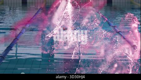 Shooting water jet glowing white and pink in swimming pool lane, with tiled floor, lane dividers Stock Photo