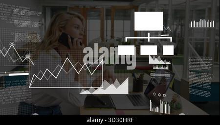 Speaking executive holding smartphone in office, with laptop notebook pen holder plant data overlay Stock Photo