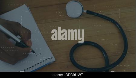 Writing hand holding black pen on lined notebook at desk, stethoscope, binary overlay, copy space Stock Photo