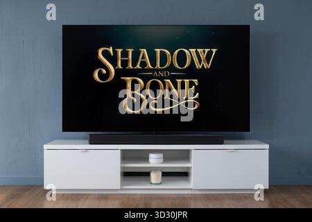 A widescreen OLED television showing the intro scene to the TV series Shadow and Bone, seen in a contemporary living room. Stock Photo