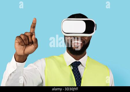 Black Builder Man Using VR Glasses And Touching Air With Finger Stock Photo
