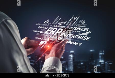 A person interacts with a smartphone showcasing ERP solutions in a modern digital landscape. The image emphasizes business management concepts and tec Stock Photo