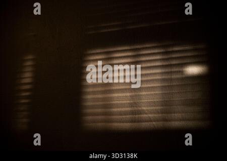 Shadow Stripes From Blinds On Wall, A striking ad photo of shadow stripes from blinds cast on a wall, light beams slicing softly, perfect for modern i Stock Photo