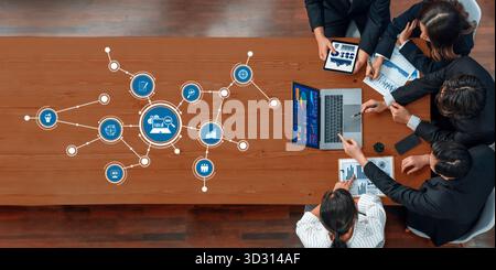 A dynamic business meeting showcasing a group collaborating on analytics and strategy, featuring digital charts and ideas for enhancing performance on Stock Photo