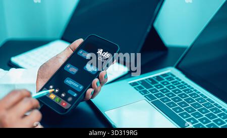 Close up of businessman using smartphone with ads chat app screen for digital marketing in modern office workspace, online advertising and communicati Stock Photo