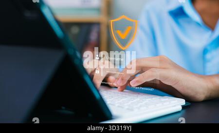 User typing on keyboard with virtual login interface and security shield icon. Concept of cybersecurity, online privacy, data protection, and secure a Stock Photo