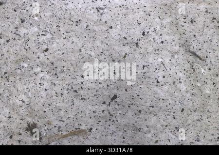 Close-up of a textured paper surface with small stones and speckles. Stock Photo