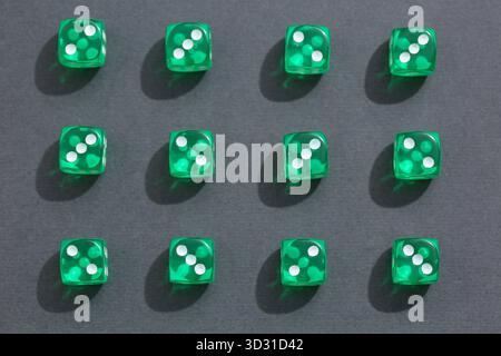 Green game dices on grey background Stock Photo