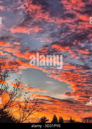 Dramatic Sunrise Clouds. Fiery Sky at Dawn. Orange and Blue Sky Panorama. Colorful Cloudscape Stock Photo
