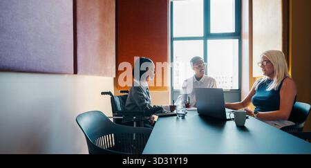 Professional women holding a business meeting in a modern corporate office, discussing ideas and collaborating for a project. Stock Photo