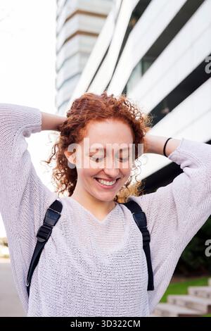 portrait of a happy young woman with curly hair Stock Photo
