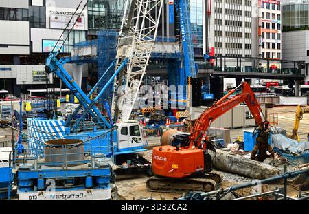 Excavators and cranes working on construction site. Shibuya, Tokyo, Japan Stock Photo