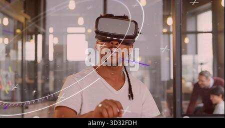 Navigating augmented reality developer wearing VR headset in coworking space with sticky notes Stock Photo