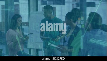 Collaborating team analyzing charts on whiteboard with notes and tablets during office meeting Stock Photo