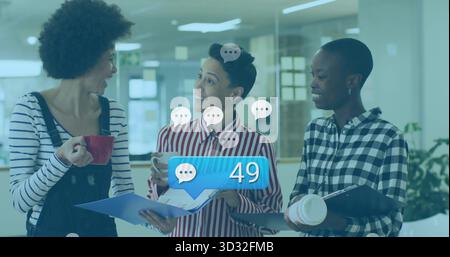 Chatting three colleagues holding coffee cups smartphone in office, chat bubbles notification icon Stock Photo