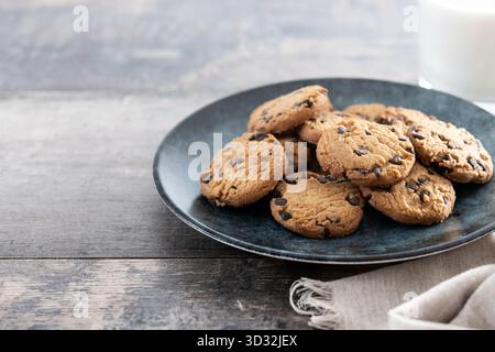 Chocolate chip cookies and milk for breakfast on rustic wooden table Stock Photo